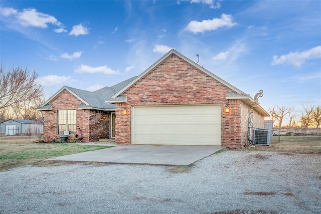 ranch-style house with an attached garage, fence, brick siding, and driveway