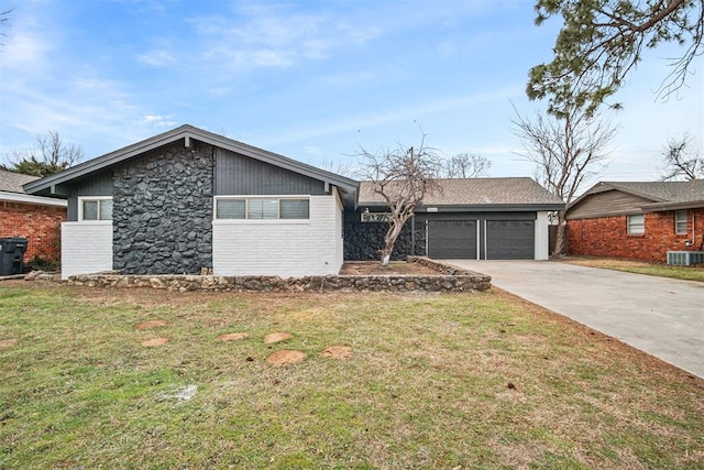 mid-century inspired home with central air condition unit, stone siding, and a front yard