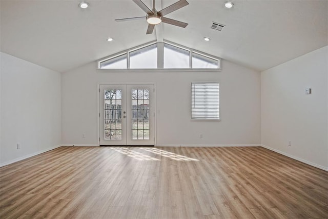 unfurnished living room featuring baseboards, visible vents, vaulted ceiling, french doors, and light wood-style floors