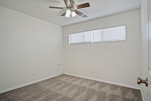 empty room featuring carpet floors, visible vents, baseboards, and a ceiling fan