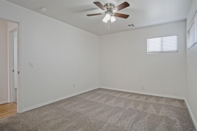 unfurnished room with a ceiling fan, baseboards, visible vents, and carpet flooring