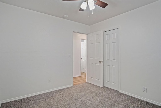 unfurnished bedroom with a ceiling fan, a closet, light colored carpet, and baseboards