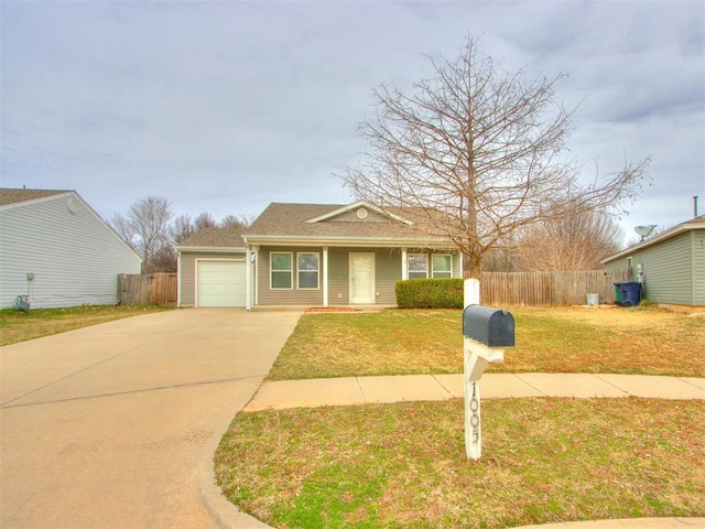 bungalow with a garage, fence, concrete driveway, and a front yard