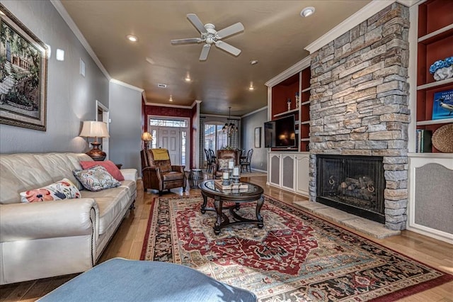 living room with ornamental molding, a fireplace, and wood finished floors