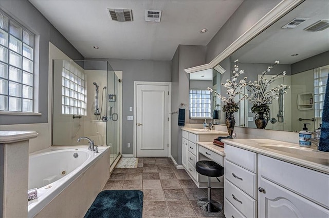 full bath with vanity, a stall shower, a jetted tub, and visible vents