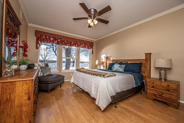 bedroom featuring crown molding, ceiling fan, baseboards, and light wood-style floors