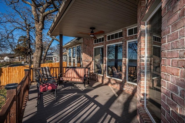 deck with ceiling fan and fence