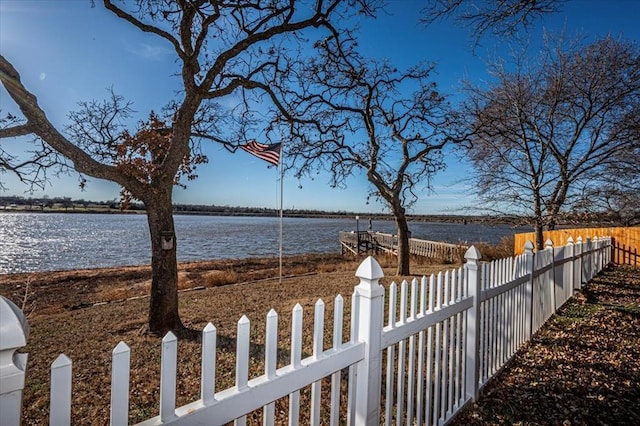 view of yard featuring a water view and fence