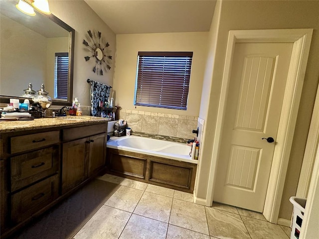 bathroom featuring vanity, a bath, and tile patterned floors