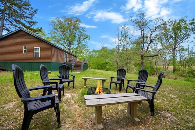 387 N Riverbend Rd, Smithville, OK 74957 - view of property's community featuring a fire pit, a yard, and stairs
