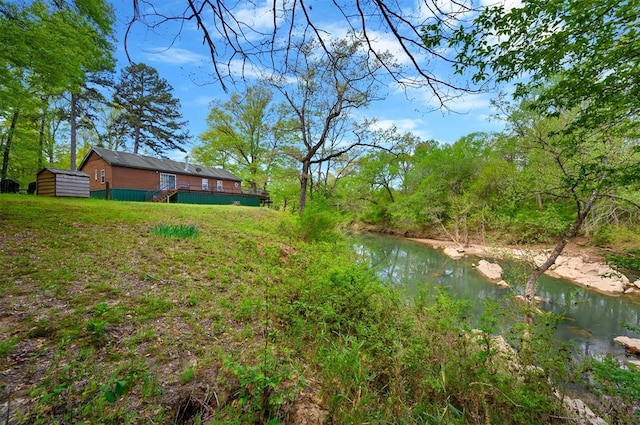 387 N Riverbend Rd, Smithville, OK 74957 - view of yard featuring an outdoor structure, a wooden deck, and a shed