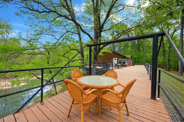 387 N Riverbend Rd, Smithville, OK 74957 - wooden deck with outdoor dining area