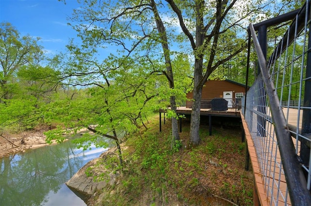 387 N Riverbend Rd, Smithville, OK 74957 - view of yard with a deck with water view