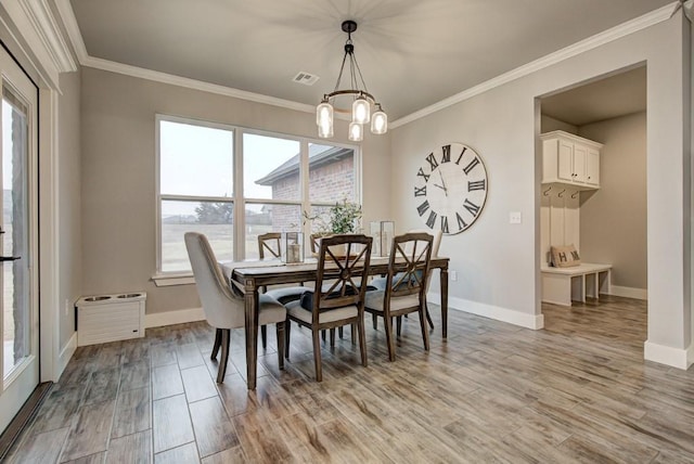 dining space with light wood finished floors, baseboards, visible vents, and a notable chandelier