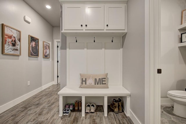 mudroom with recessed lighting, baseboards, and wood finished floors