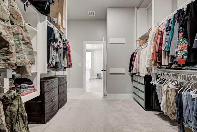 spacious closet featuring light carpet and visible vents