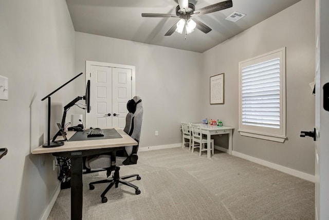 office area featuring ceiling fan, carpet flooring, visible vents, and baseboards