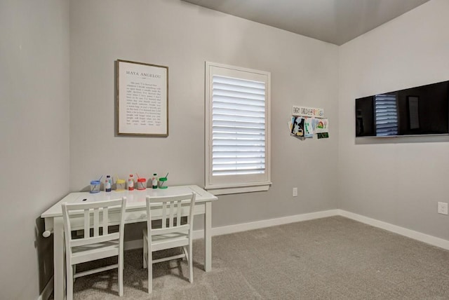 dining space with carpet flooring and baseboards