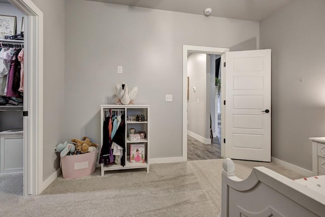 bedroom with a closet, carpet flooring, and baseboards