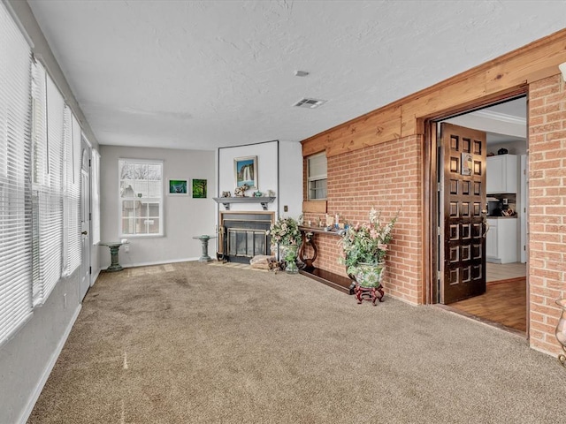 interior space with a fireplace with flush hearth and visible vents