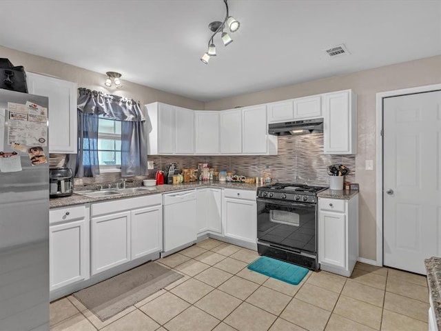 kitchen featuring backsplash, black range with gas stovetop, freestanding refrigerator, dishwasher, and under cabinet range hood