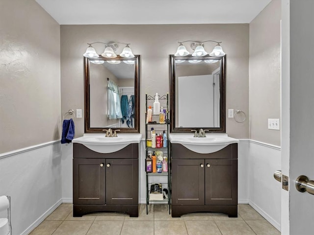 bathroom with a sink, two vanities, and tile patterned floors