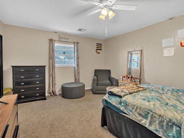 carpeted bedroom with baseboards, visible vents, and a ceiling fan