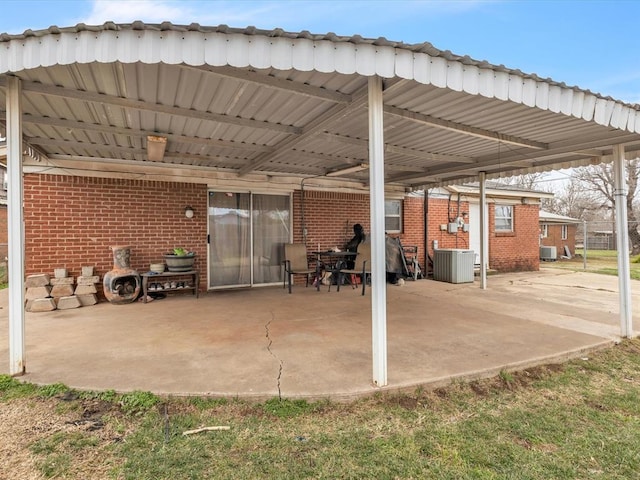 view of patio / terrace featuring central air condition unit and a carport