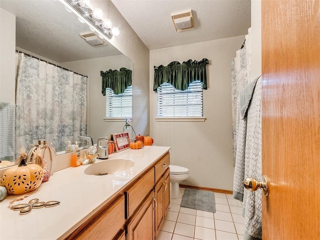 full bathroom featuring visible vents, toilet, vanity, a textured ceiling, and tile patterned flooring