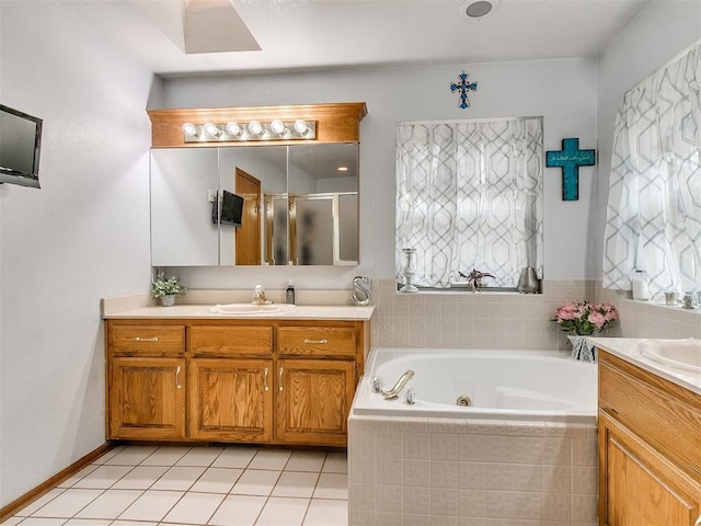 full bath featuring two vanities, a sink, a shower stall, tile patterned flooring, and a whirlpool tub