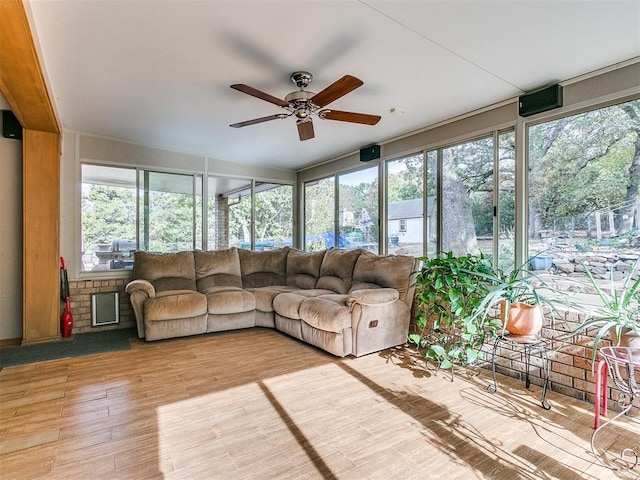 unfurnished sunroom with ceiling fan