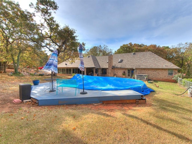 view of pool with a lawn and a deck