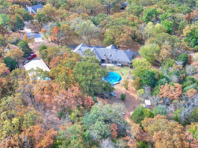 drone / aerial view featuring a wooded view