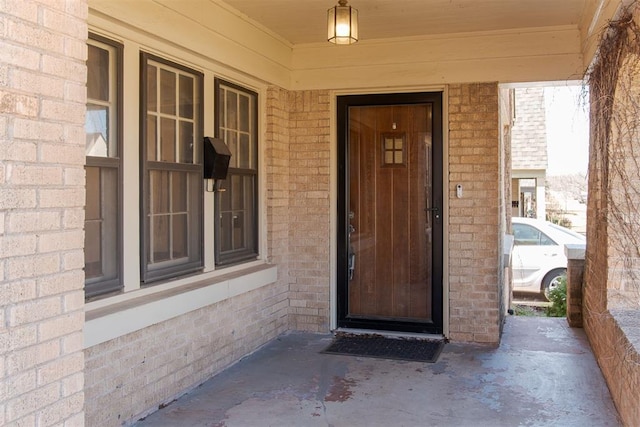 property entrance with brick siding