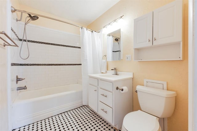 bathroom with vanity, shower / bath combo with shower curtain, and toilet