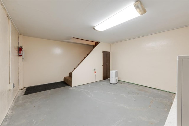 finished basement featuring washer / clothes dryer and stairway