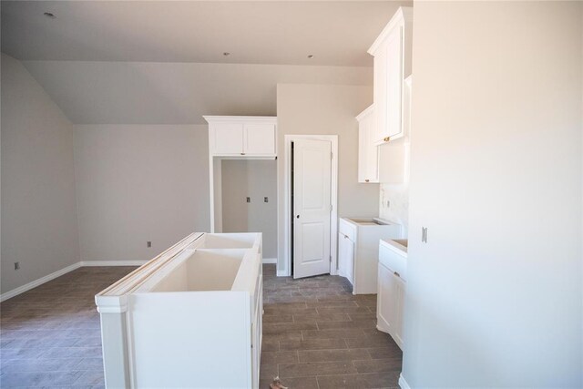3817 Lynne Ave, Edmond, OK 73012 - kitchen with a kitchen island with sink, white cabinets, and dark wood-style floors