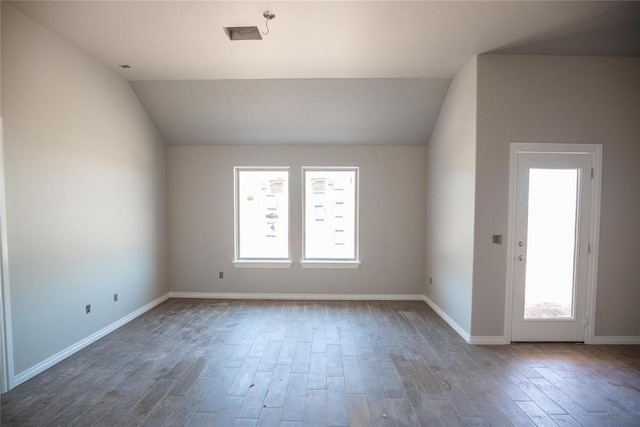 3817 Lynne Ave, Edmond, OK 73012 - spare room featuring vaulted ceiling and wood finished floors
