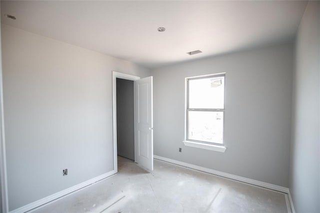 3817 Lynne Ave, Edmond, OK 73012 - unfurnished bedroom featuring baseboards and concrete flooring