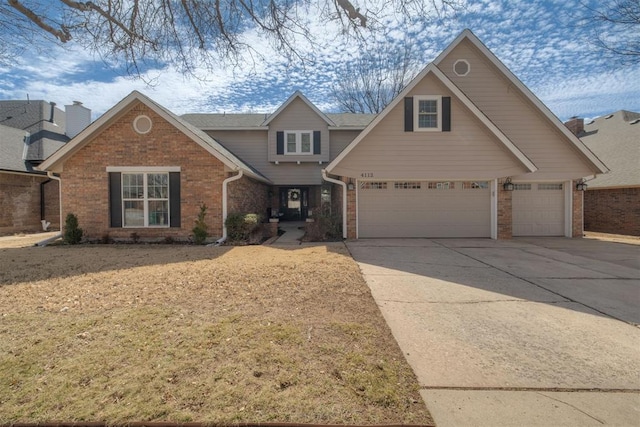 view of front facade with a garage, brick siding, and driveway