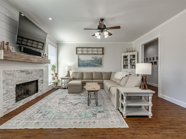 living area with baseboards, dark wood finished floors, a ceiling fan, and crown molding