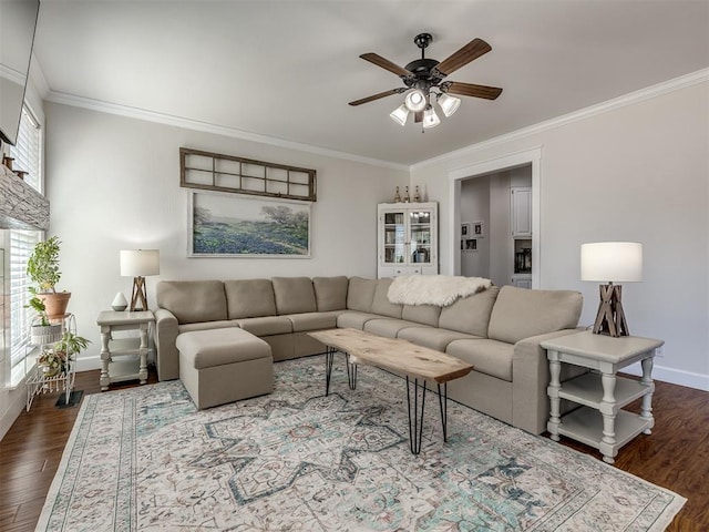 living area featuring a ceiling fan, crown molding, baseboards, and dark wood-style flooring