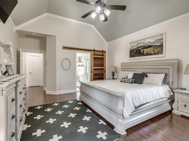 bedroom with crown molding, lofted ceiling, visible vents, a barn door, and dark wood-type flooring