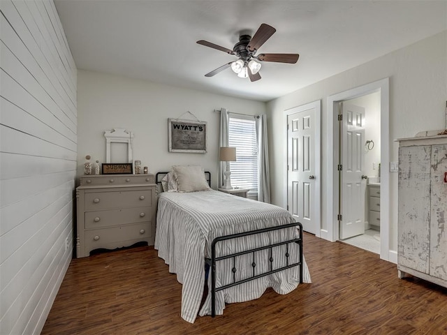 bedroom featuring ceiling fan, ensuite bathroom, and wood finished floors