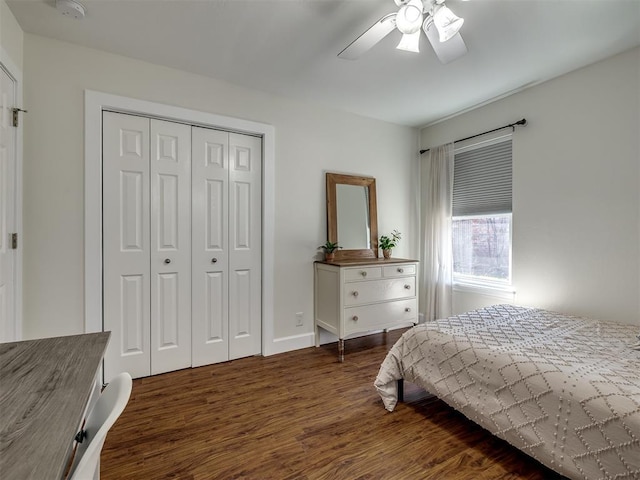 bedroom with a closet, dark wood finished floors, and ceiling fan