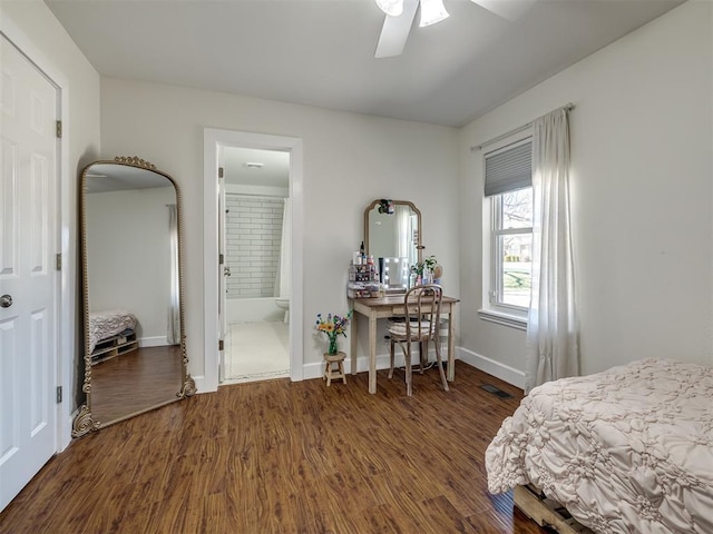 bedroom with visible vents, ensuite bathroom, baseboards, and wood finished floors