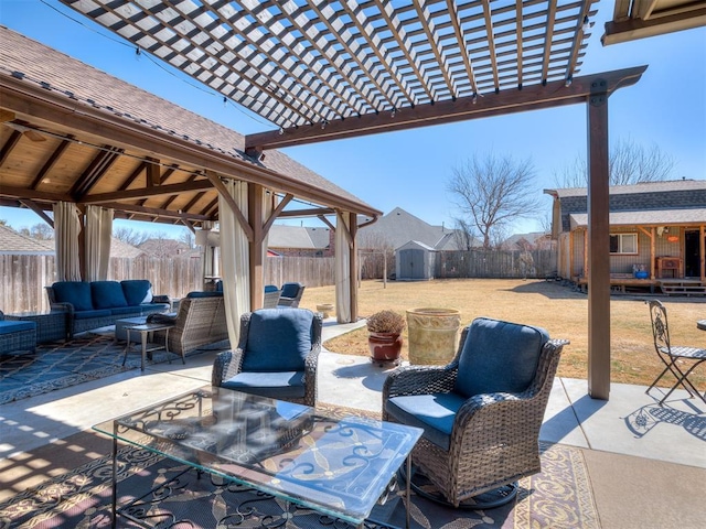 view of patio / terrace with a fenced backyard, an outdoor structure, a gazebo, and an outdoor hangout area