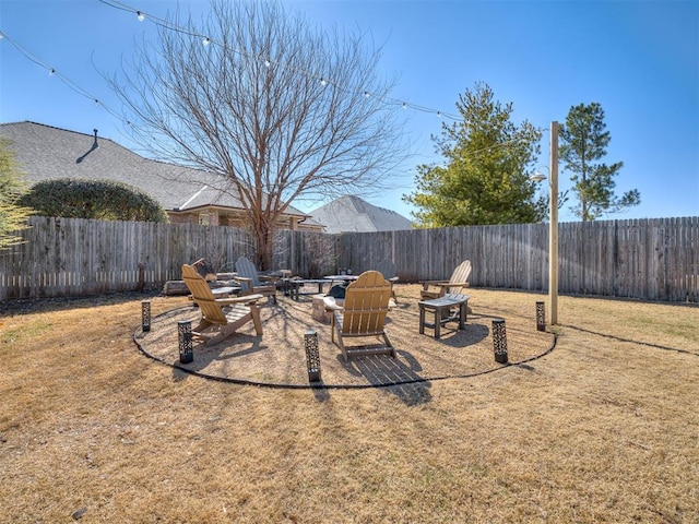 view of yard with an outdoor fire pit and a fenced backyard