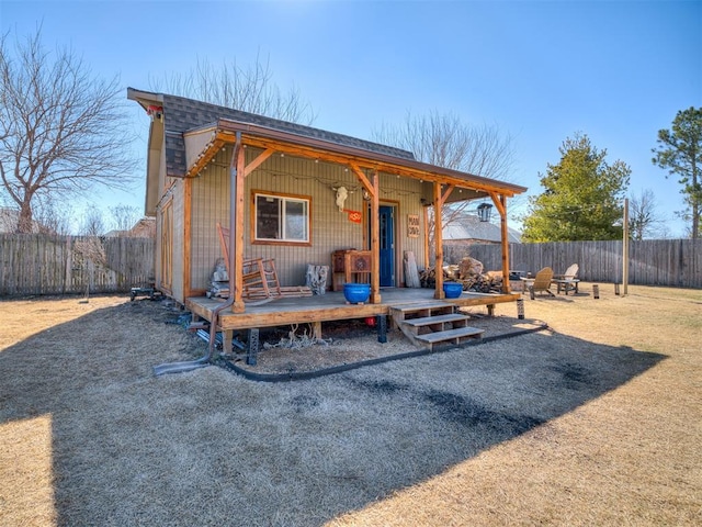 exterior space featuring a shingled roof and a fenced backyard