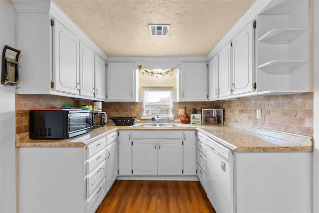 kitchen featuring black microwave, a sink, white cabinetry, dishwasher, and open shelves